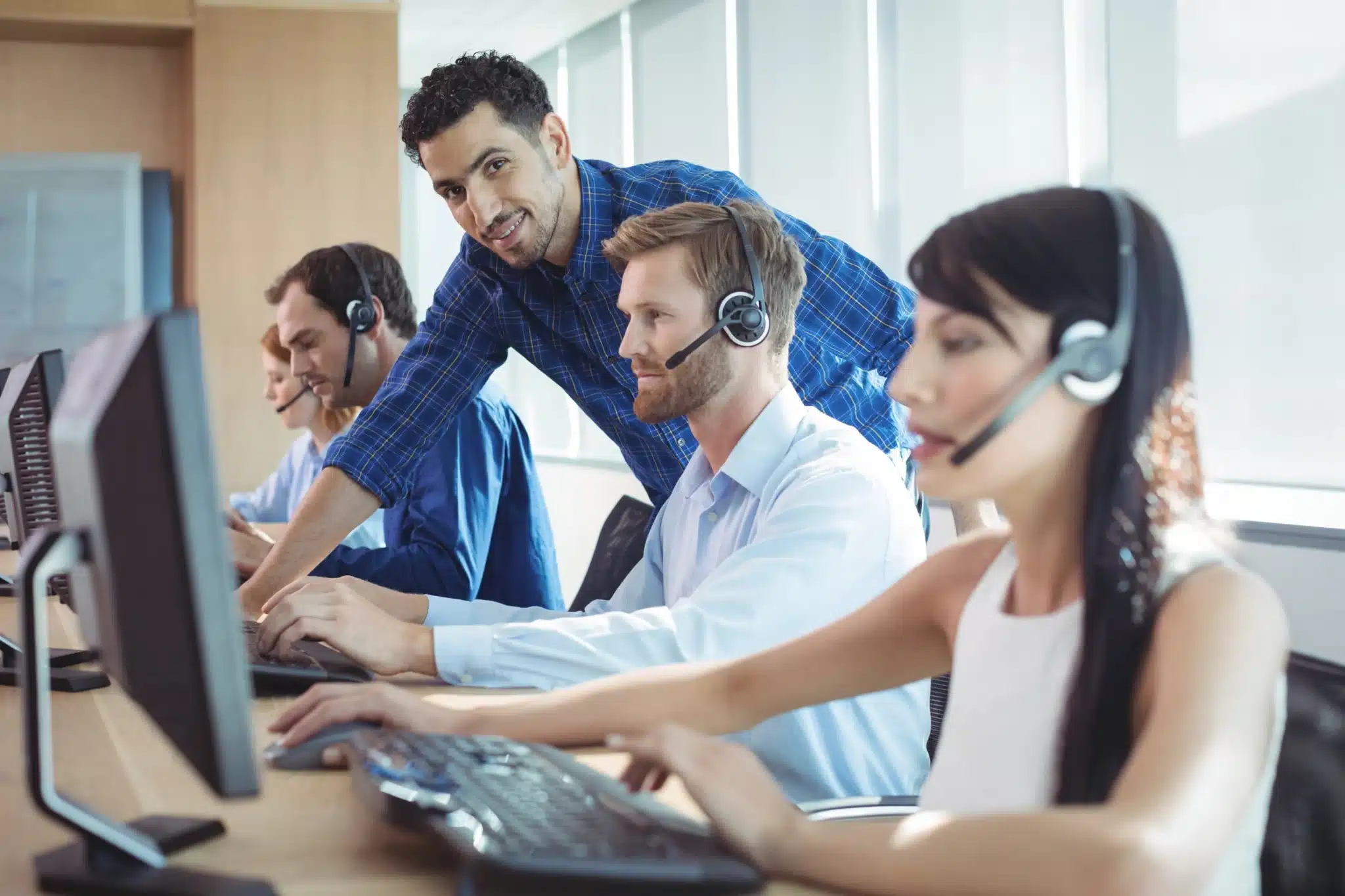 Call center telemarketing services team handling outbound sales calls with CRM technology